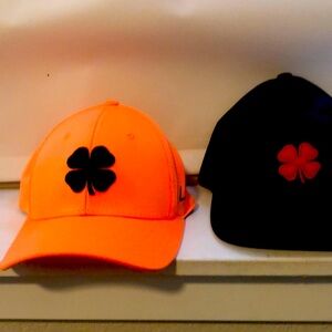 2 Worn Once Black Clover fitted golf hats. Size s-m. 1 orange 1 Black Camo